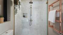 The jaw-dropping bathroom, where you'll find a large walk-in shower, elegant Moroccan tiles, and a beautiful copper rail for keeping towels warm and fluffy 