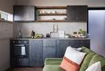 We adore the bespoke blackened steel cabinets