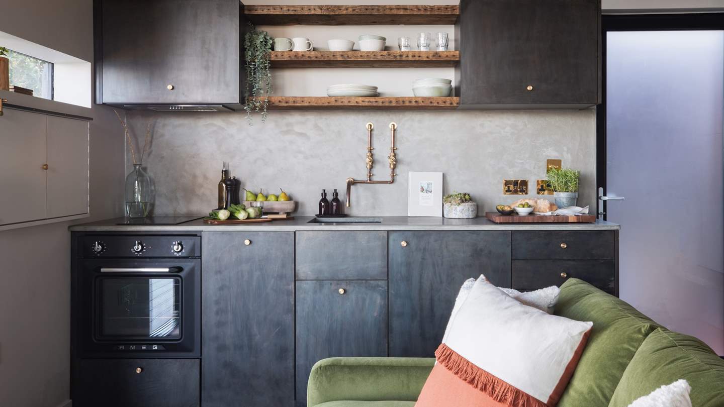 We adore the bespoke blackened steel cabinets