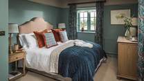 The second bedroom is dressed in decedent shades of teal 