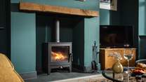 Keep toasty and warm by the flickering wood burner 