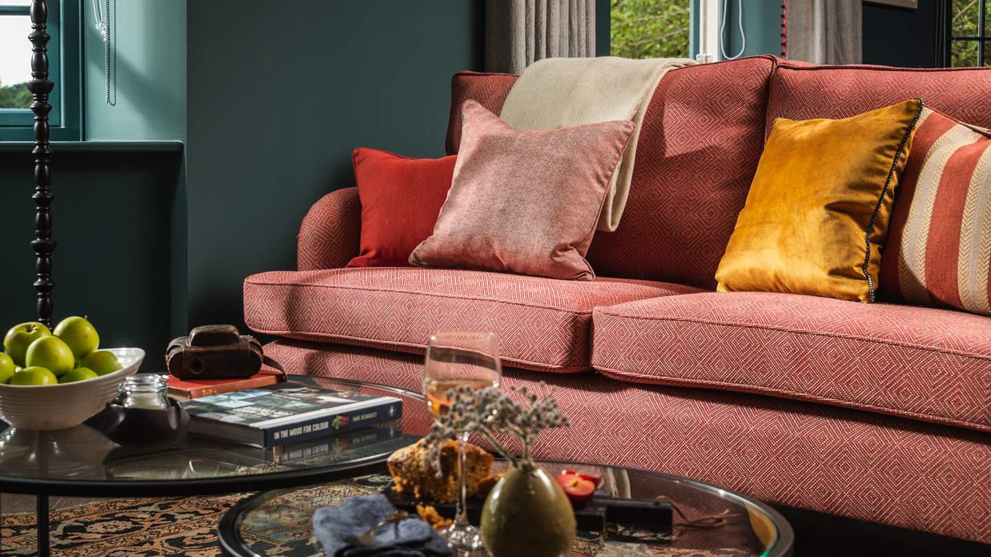 At the far end, find the stunning sitting room, with gorgeous bespoke sofas 