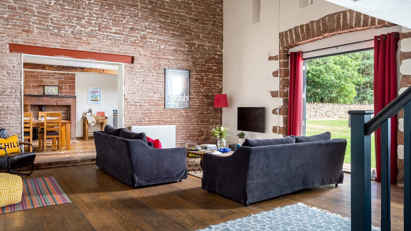 We adore the rustic features of the open plan living space, with exposed brick and vaulted ceilings 