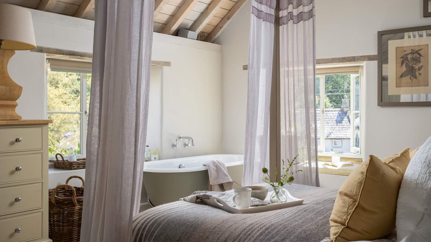 The master bedroom is oh-so-romantic, with a four-poster bed and roll top bath 