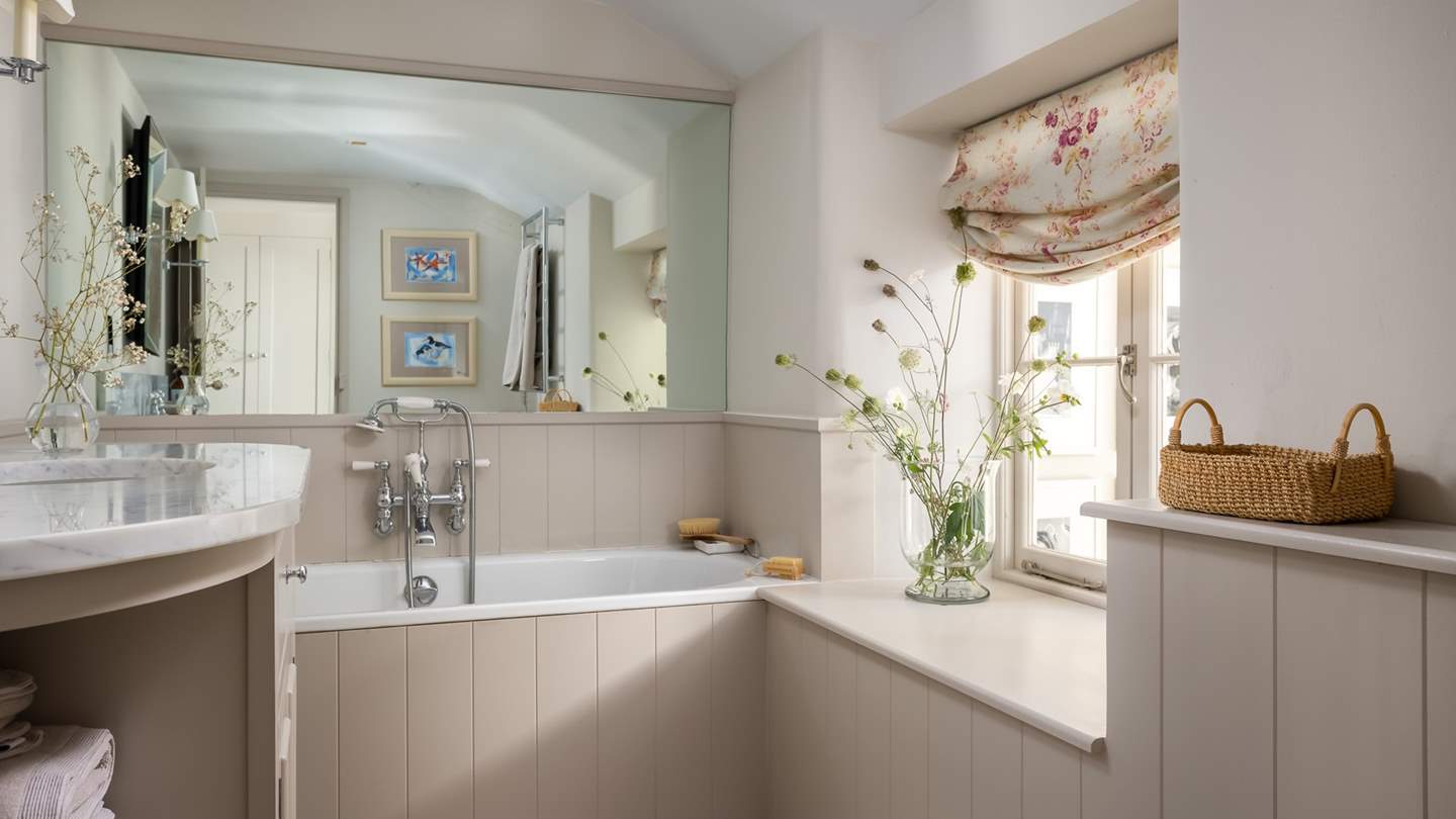 We adore the soft tones in the family bathroom, complete with an overhead shower