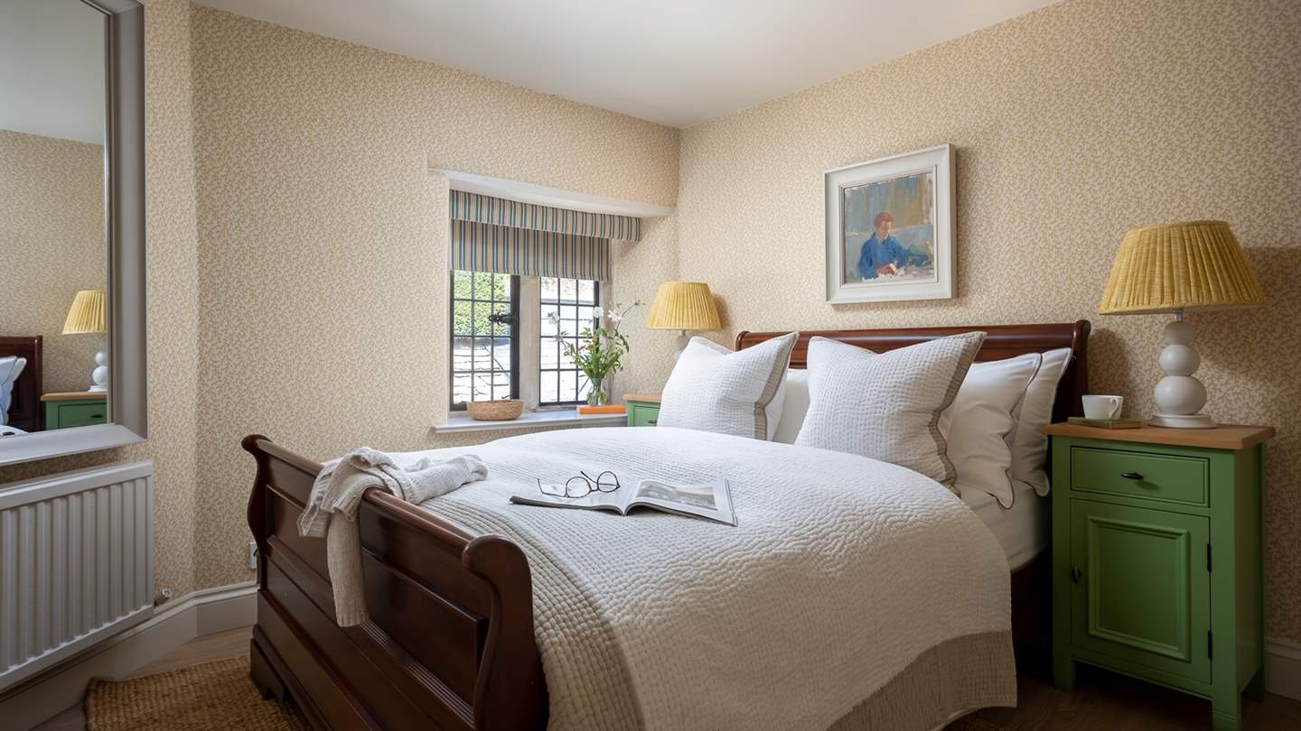 The fifth bedroom has stunning wooden sleigh-style double bed 