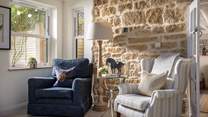 This charming reading nook is complete with an exposed Cotswold stone feature wall