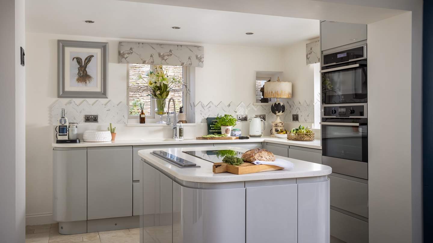 The sleek central island ensures plentiful space for crafting culinary delights