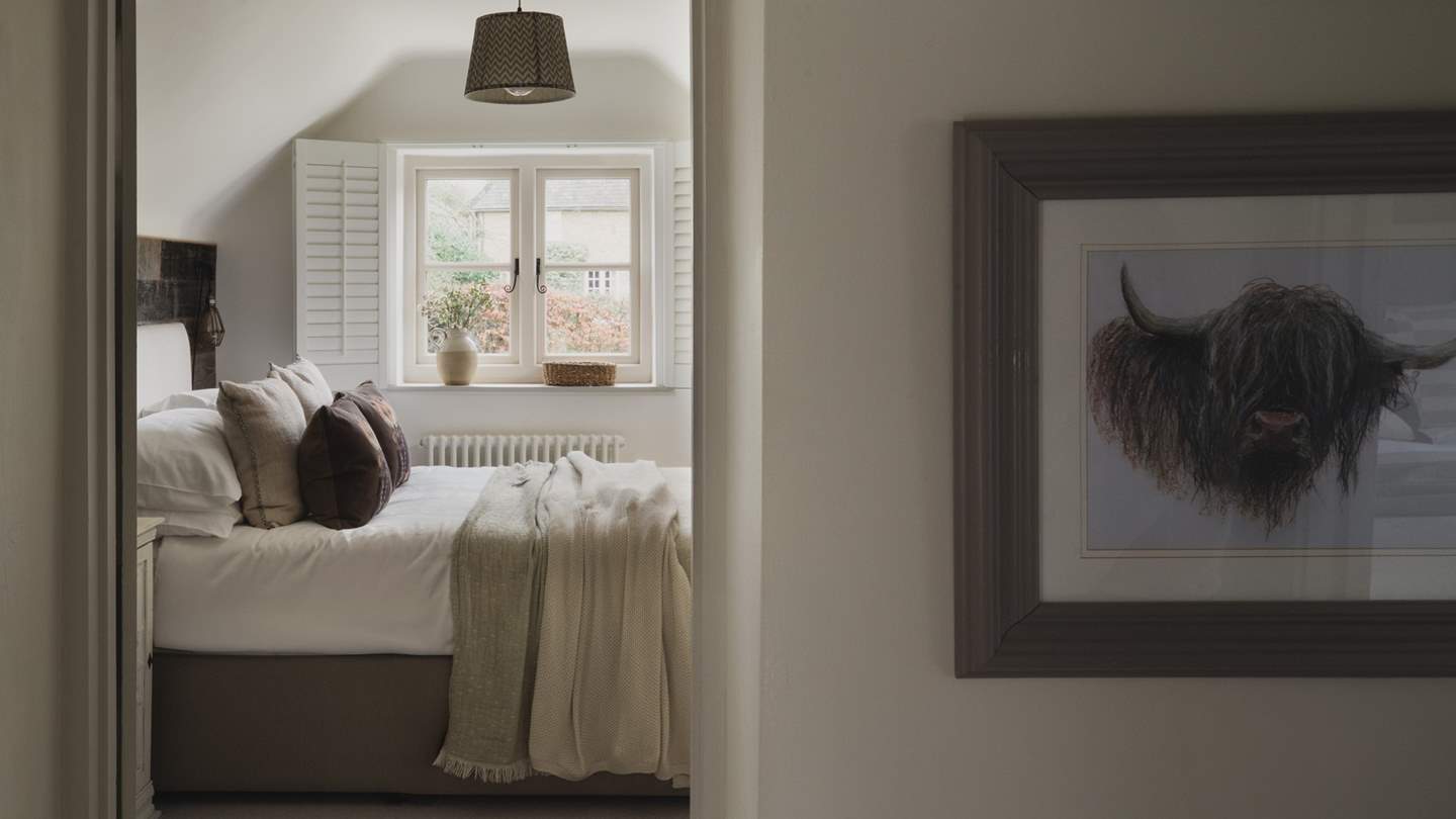 The darling second bedroom with a double bed and is equally lovely in rich chocolate tones