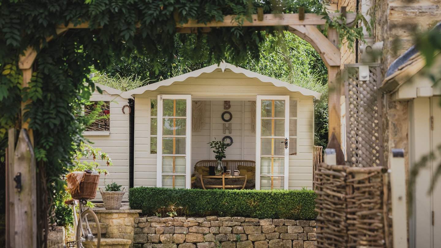 For those looking for a serene spot, there's a wonderful summerhouse complete with wicker chairs, cosy throws, and a glass coffee table