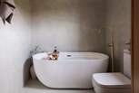 Savour bubble-topped soaks in the opulent freestanding bath