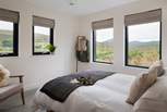 The master bedroom overlooks lush green fields