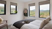 The master bedroom overlooks lush green fields