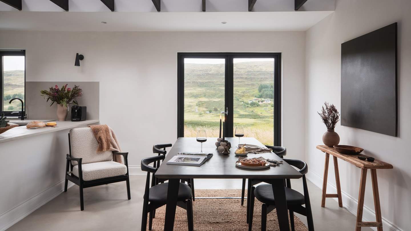 The striking open-plan living space is simply sumptuous, with jet-black beams contrasting dove-grey cement flooring to create an effortlessly contemporary space