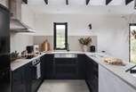 The chic kitchen with stylish black cabinets has all you should need during your stay... 