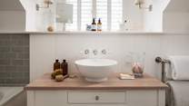 The ensuite is complete with an elegant wash basin
