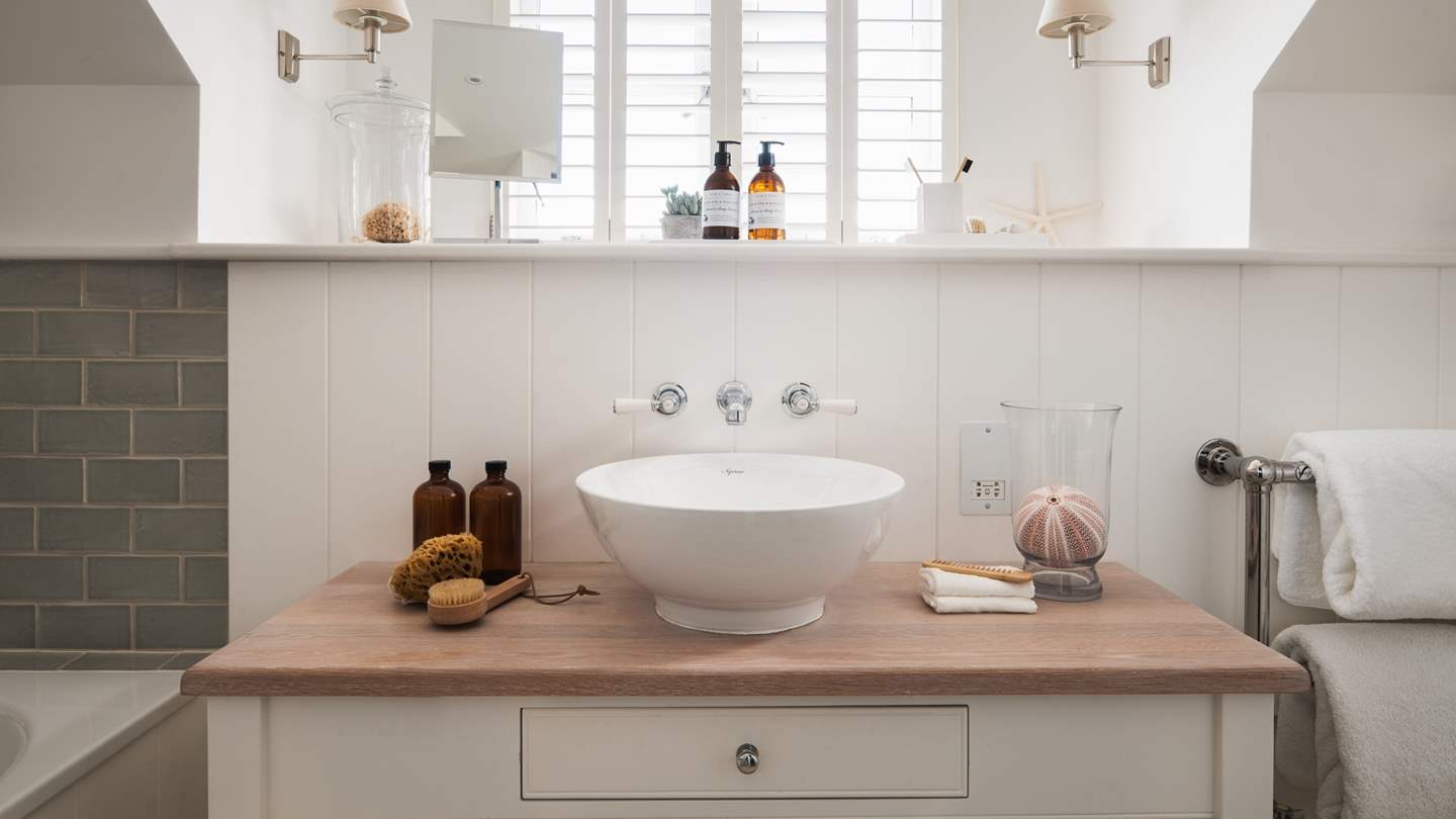 The ensuite is complete with an elegant wash basin