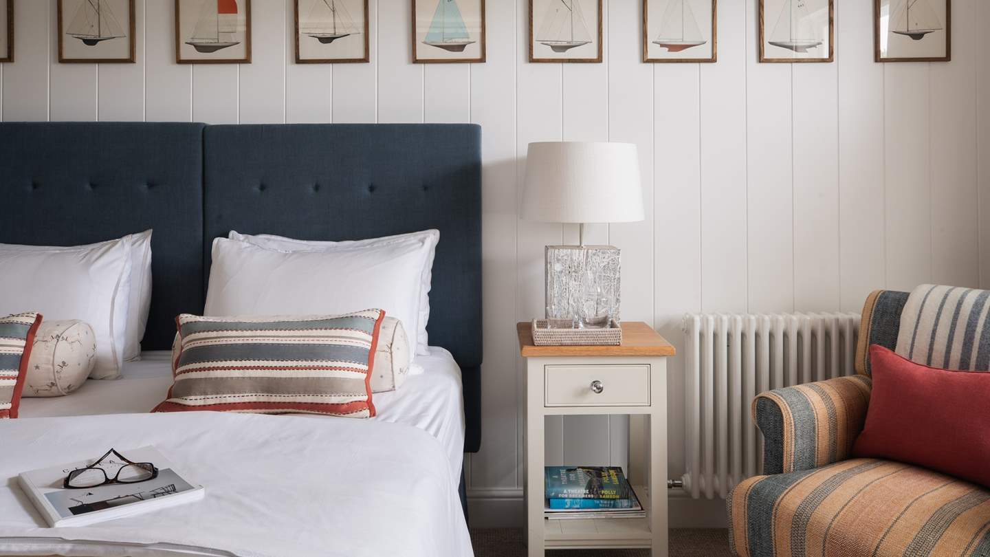 The charming striped armchair is a wonderful nook to enjoy your current page turner... 