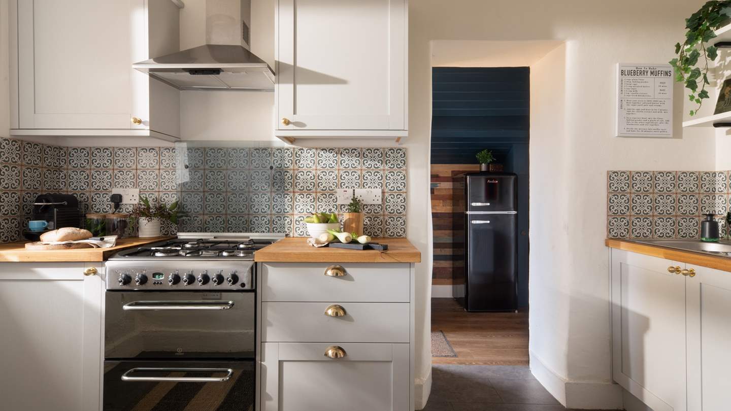 Moroccan-inspired tiles playfully complement the neutral shades of the pretty cottage kitchen 