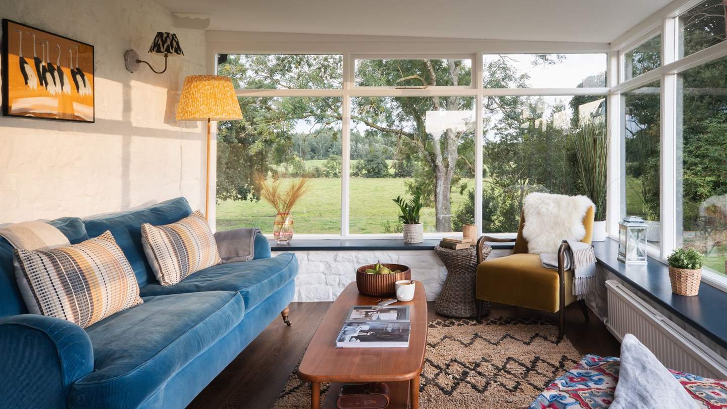 Vast windows showcase the captivating views from the gorgeous living space