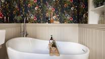 With striking exotic wallpaper, this en-suite is an opulent yet playful space 
