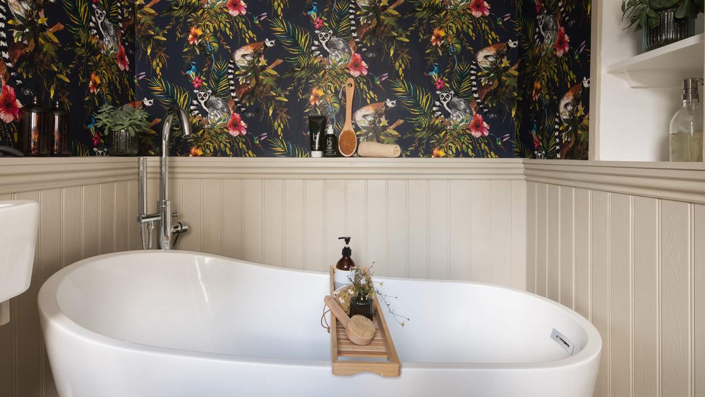 With striking exotic wallpaper, this en-suite is an opulent yet playful space 