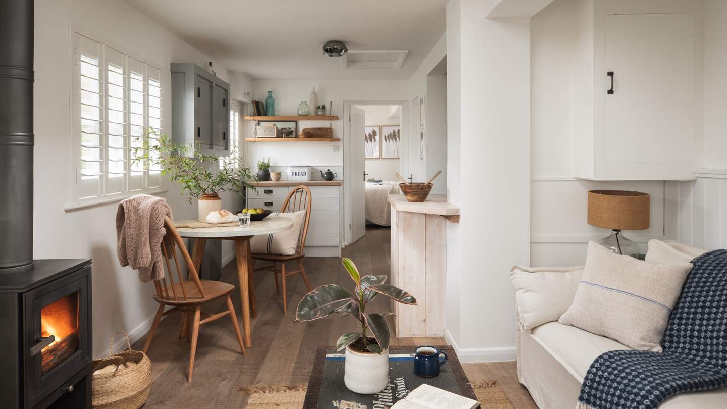 Snug staycation moments await beside the sleek wood burning stove...