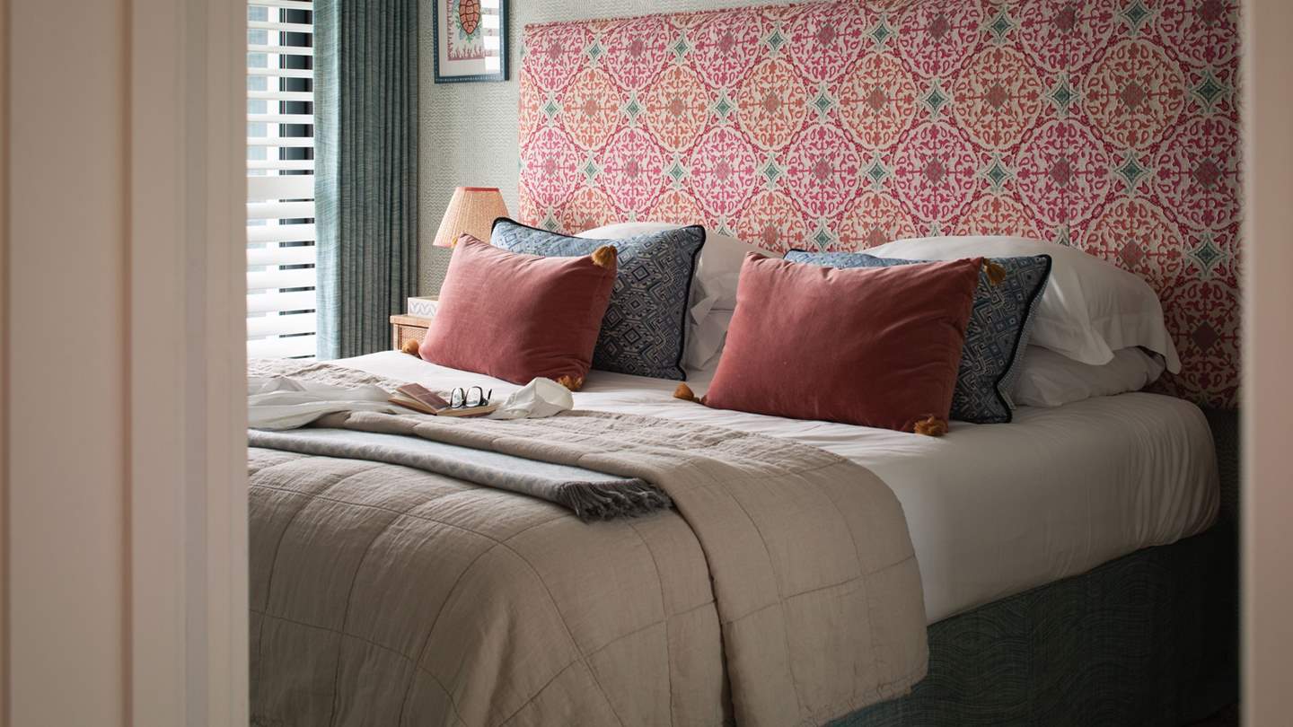 We adore the Orient-inspired headboard in the fourth bedroom 