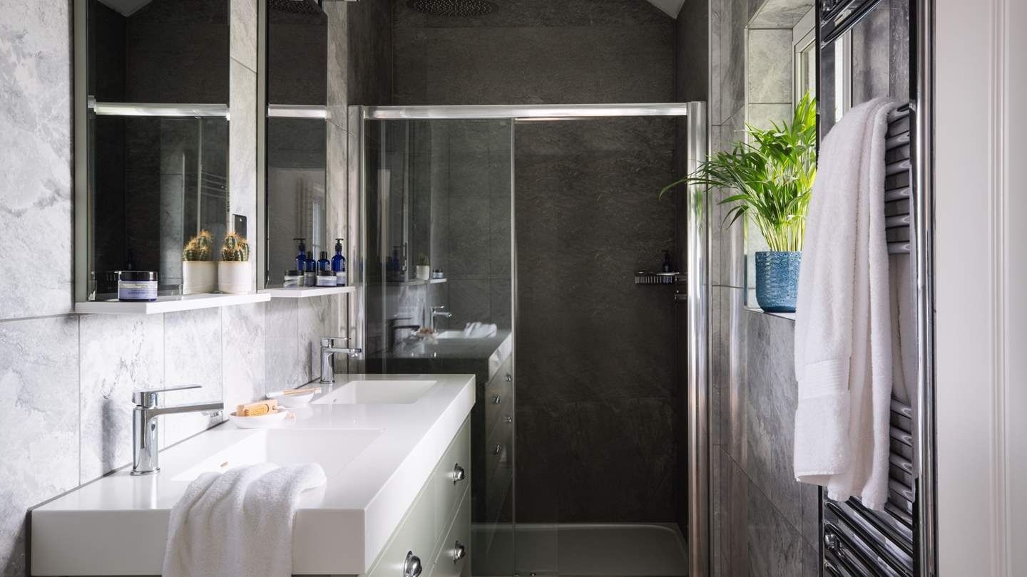 The stylish en suite has a rainfall shower for refreshing wake up moments 