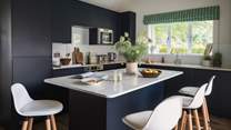 With deep ocean blues and silky white features, the kitchen is a dream for crafting culinary delights