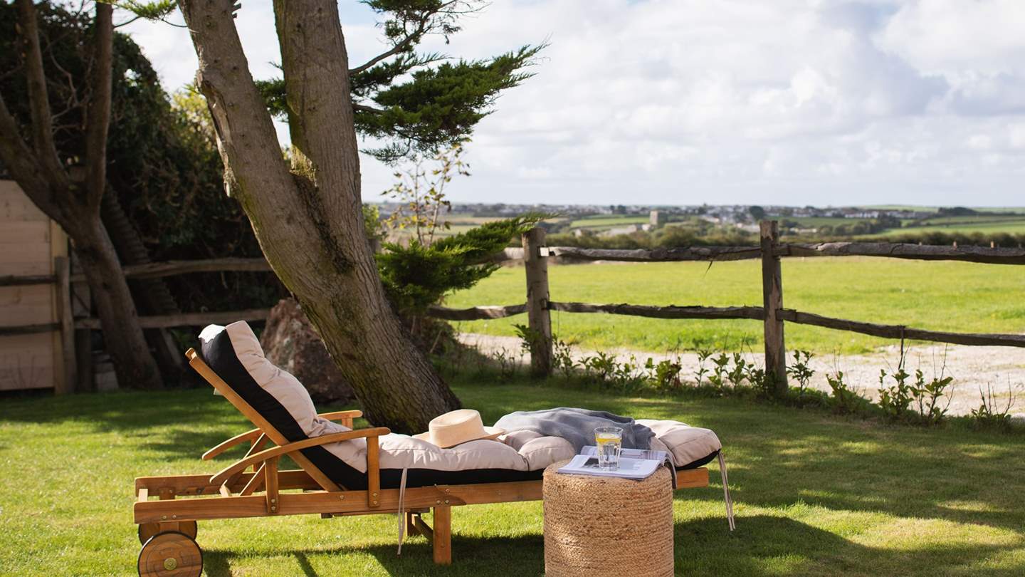 Settle on the reclining lounger for a dose of sun-soaked quietude