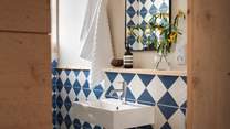 Two of the bathrooms are embellished with striking Blue Churriana tiling by Bert and May