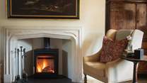 In cooler seasons, the handsome Hunter wood burning stove promises snug moments