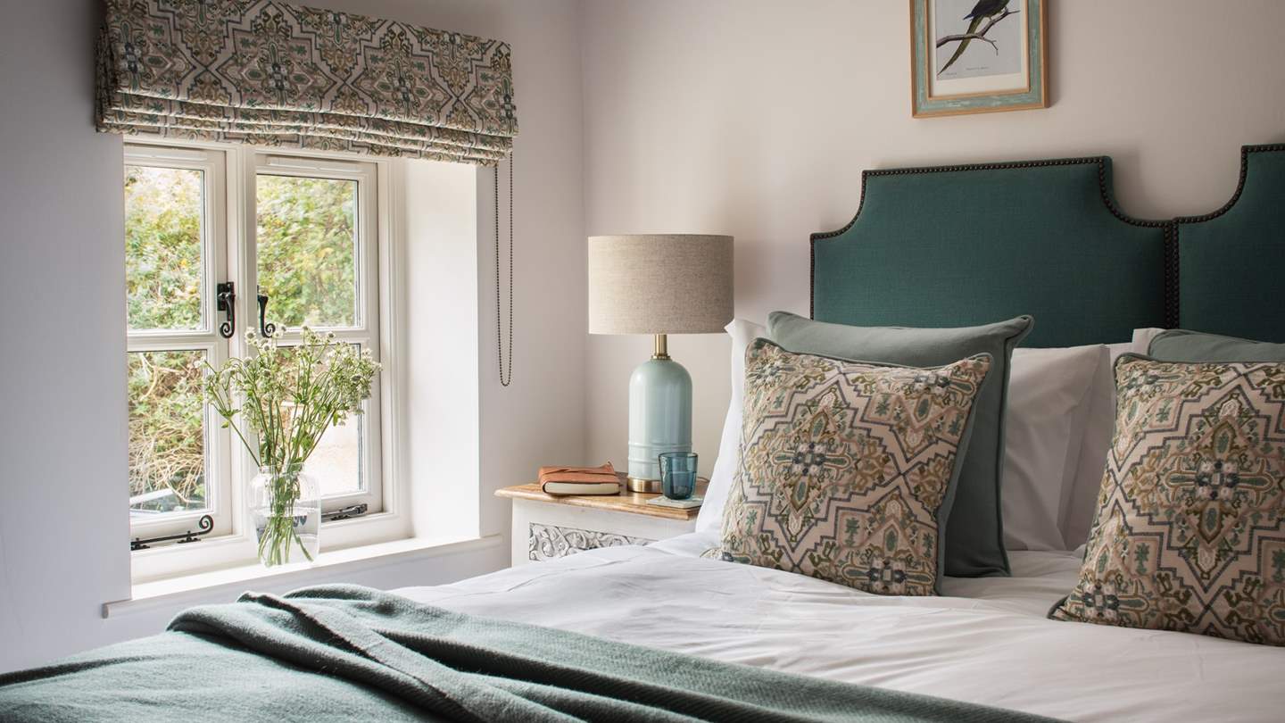 The second bedroom is adorned in an assortment of green tones