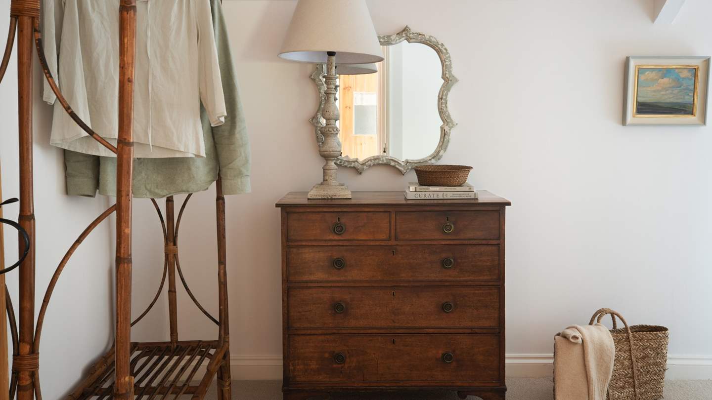 We love the quirky bamboo hanging rail and vintage mirror
