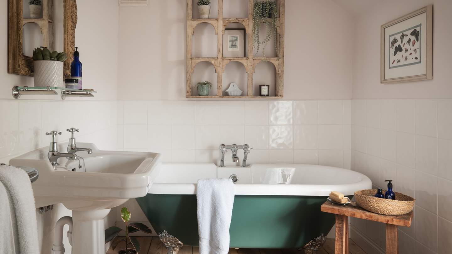 In the pretty family bathroom, you’ll find a beautiful free-standing roll top bathtub for relaxing after indulgent days out