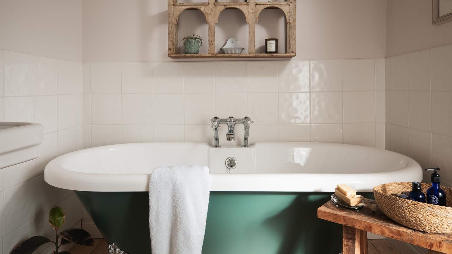 In the pretty family bathroom, you’ll find a beautiful free-standing roll top bathtub for relaxing after indulgent days out