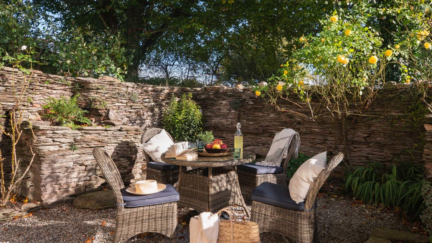 The enchanting walled courtyard promises a peaceful setting for moments of relaxation