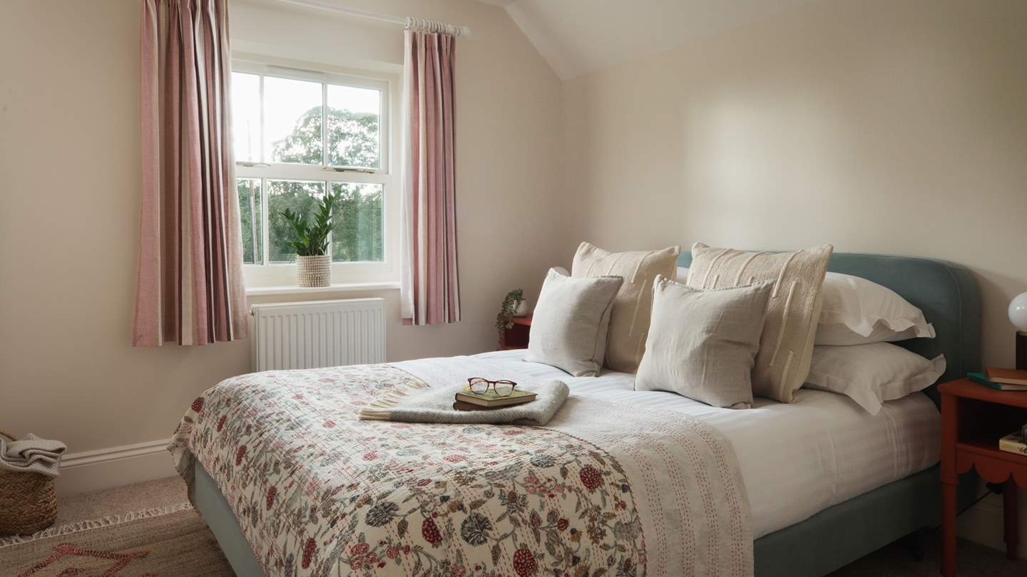 Bedroom two continues the natural interior style, adorned with vintage pieces and subtle waves of colour