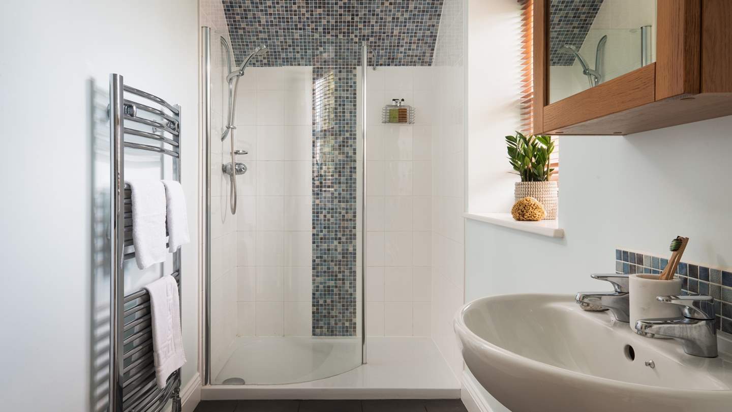 An ensuite bathroom lies adjacent to the bedroom, offering a cerulean escape with steamy showers.