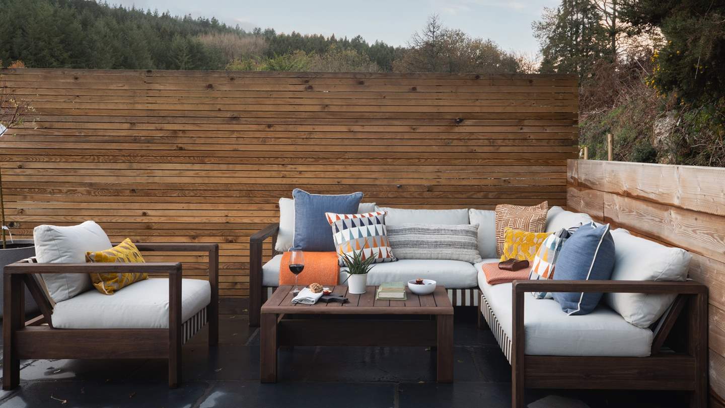 A comfortable corner sofa and armchair reside on the rooftop terrace or sun-soaked moments of bliss 