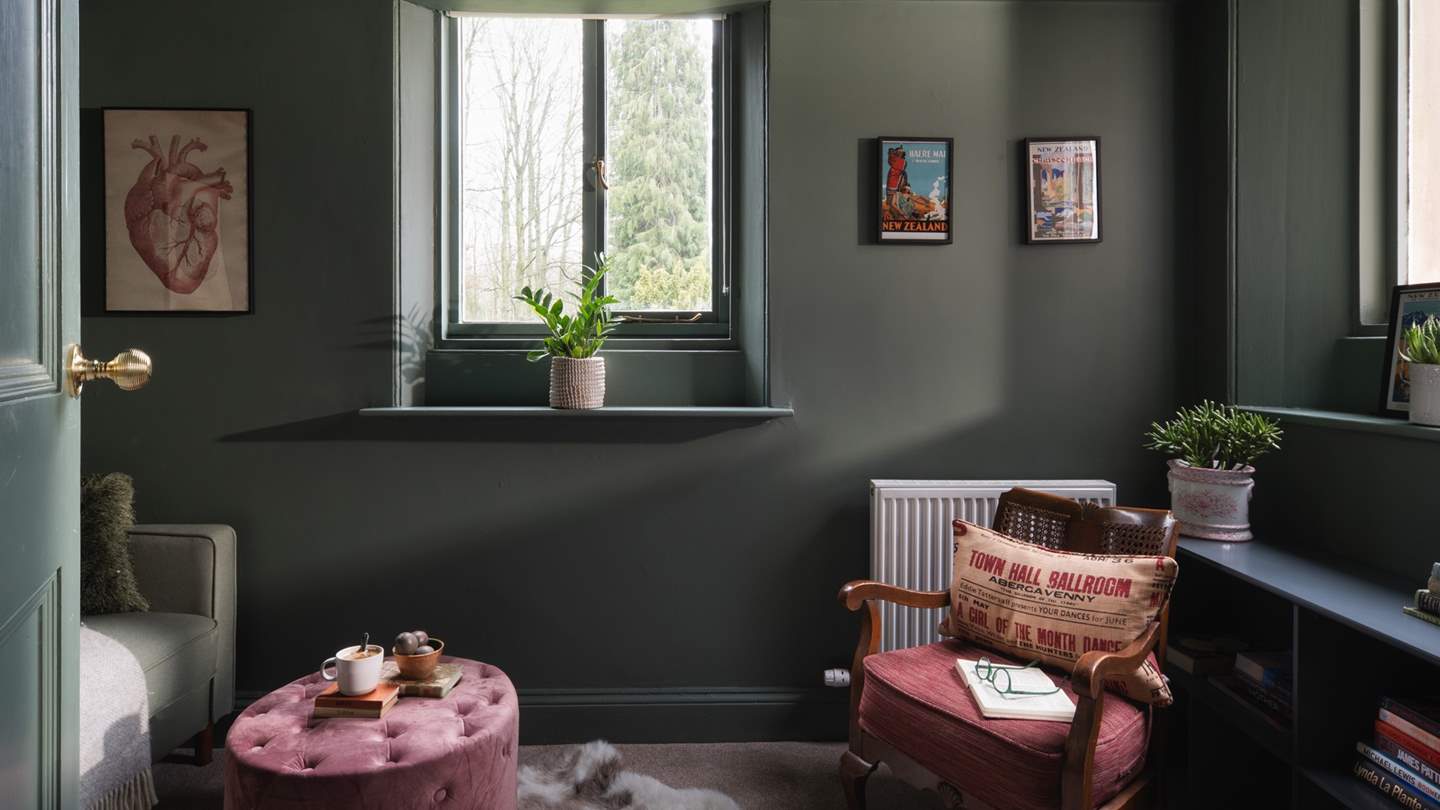 A snug study, in rich earthy tones, offers the perfect space for those looking to catch up on an email or two