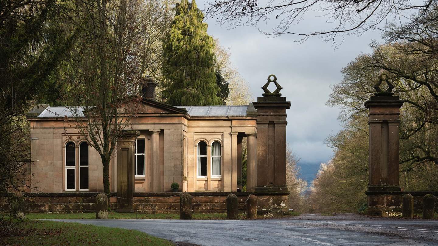 Khari sits beside grand pillars, which mark the entrance to Edenhall Estate