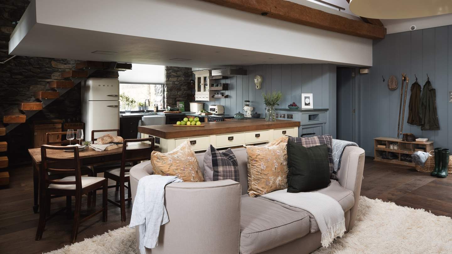 The Barn is effortlessly stylish with a snowy-white rug, bespoke coffee table, and statement pendant lighting