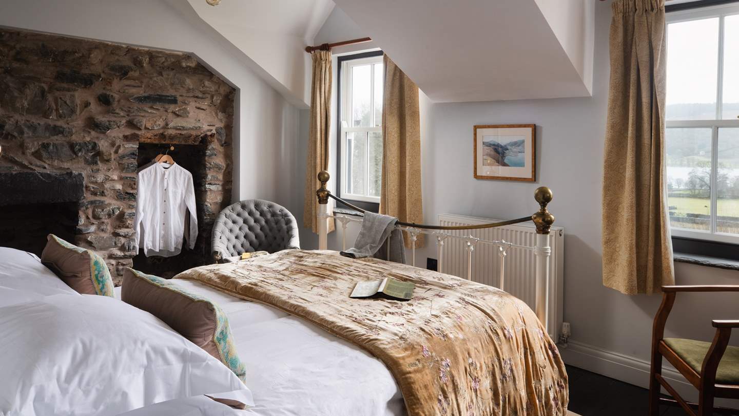 The darling second bedroom with a brass iron king-sized bed is equally charming