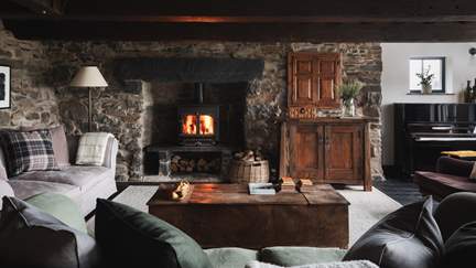 Drawing inspiration from the surrounding scenery with quirky beamed ceilings and natural stone walls, discover a homely blend of rustic and contemporary touches in the cosy sitting room