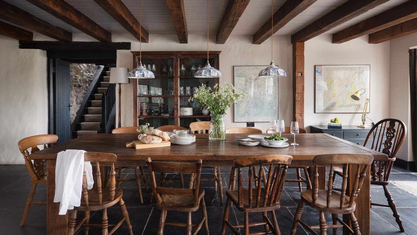 Family feasting and lavish dinner parties await around the large rustic wooden dining table for twelve...