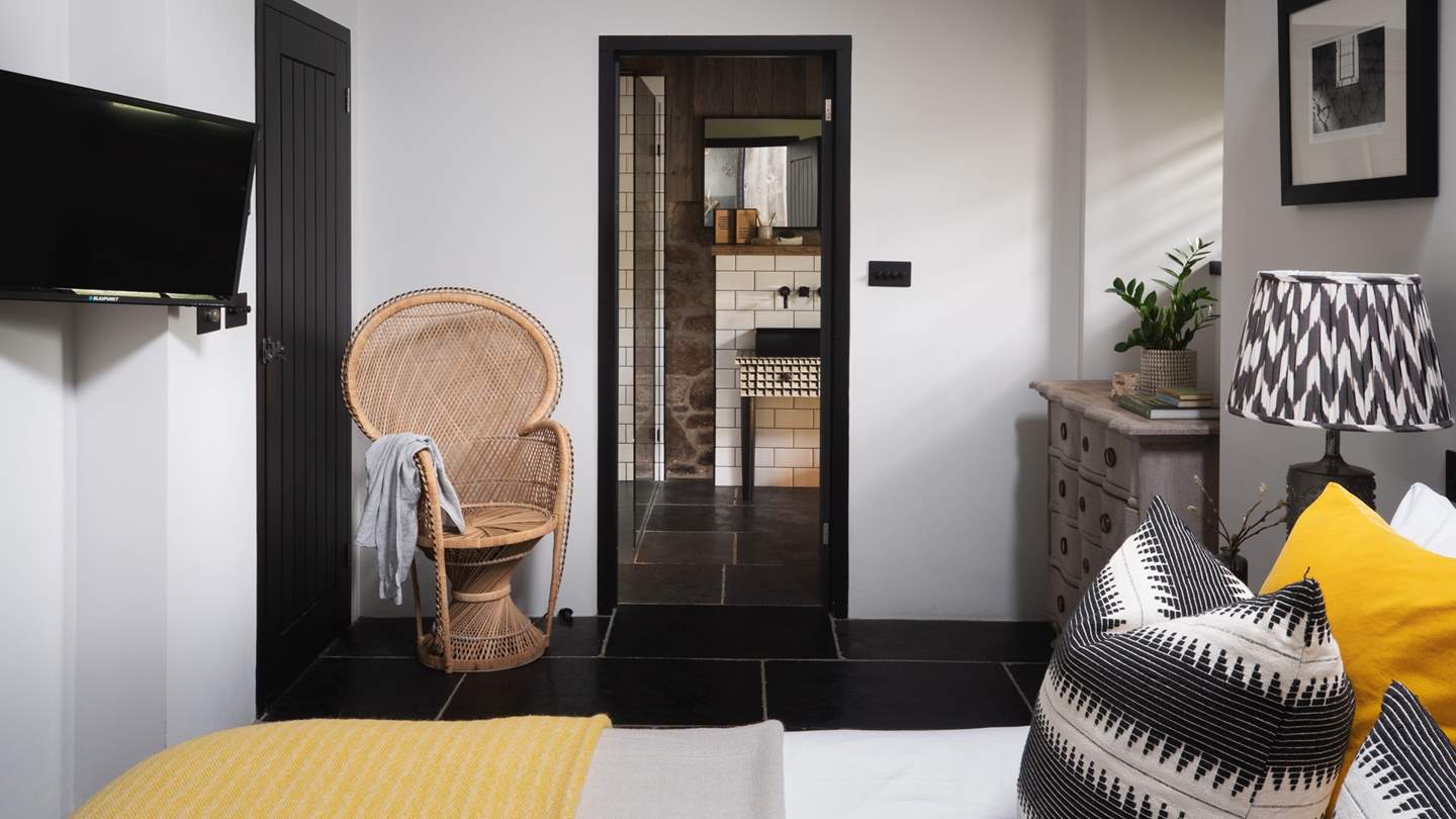 Within the bedroom, you will find a TV and an eclectic dresser for storing your belongings