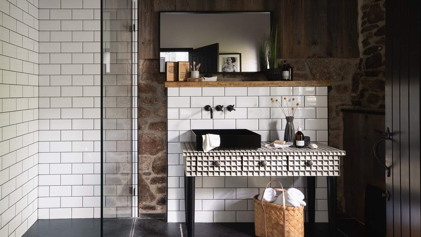 The shower room adjoins the master bedroom, with a large walk-in rainfall shower