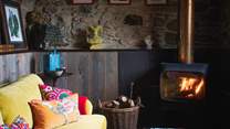 Settle beside the beautifully modern wood burner, with an eye-catching flue in shades of copper